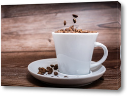  Black coffee foil packaging bag on wooden table top view. Spilled beans flat lay concept. Room for text.